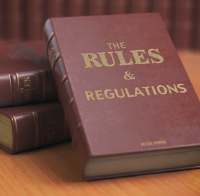 A stack of books titled Rules and Regulations