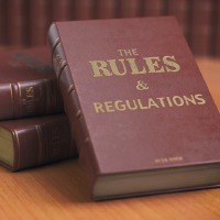 A stack of books titled Rules and Regulations